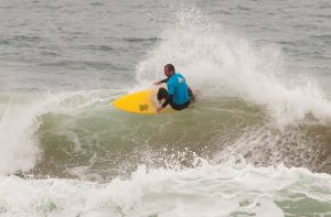 Surfers ride the perfect swell