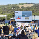 The crowd watchong thr heats on the big screen