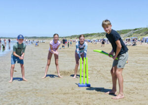 Beach cricket at summertime