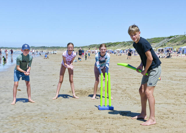 Beach cricket at summertime